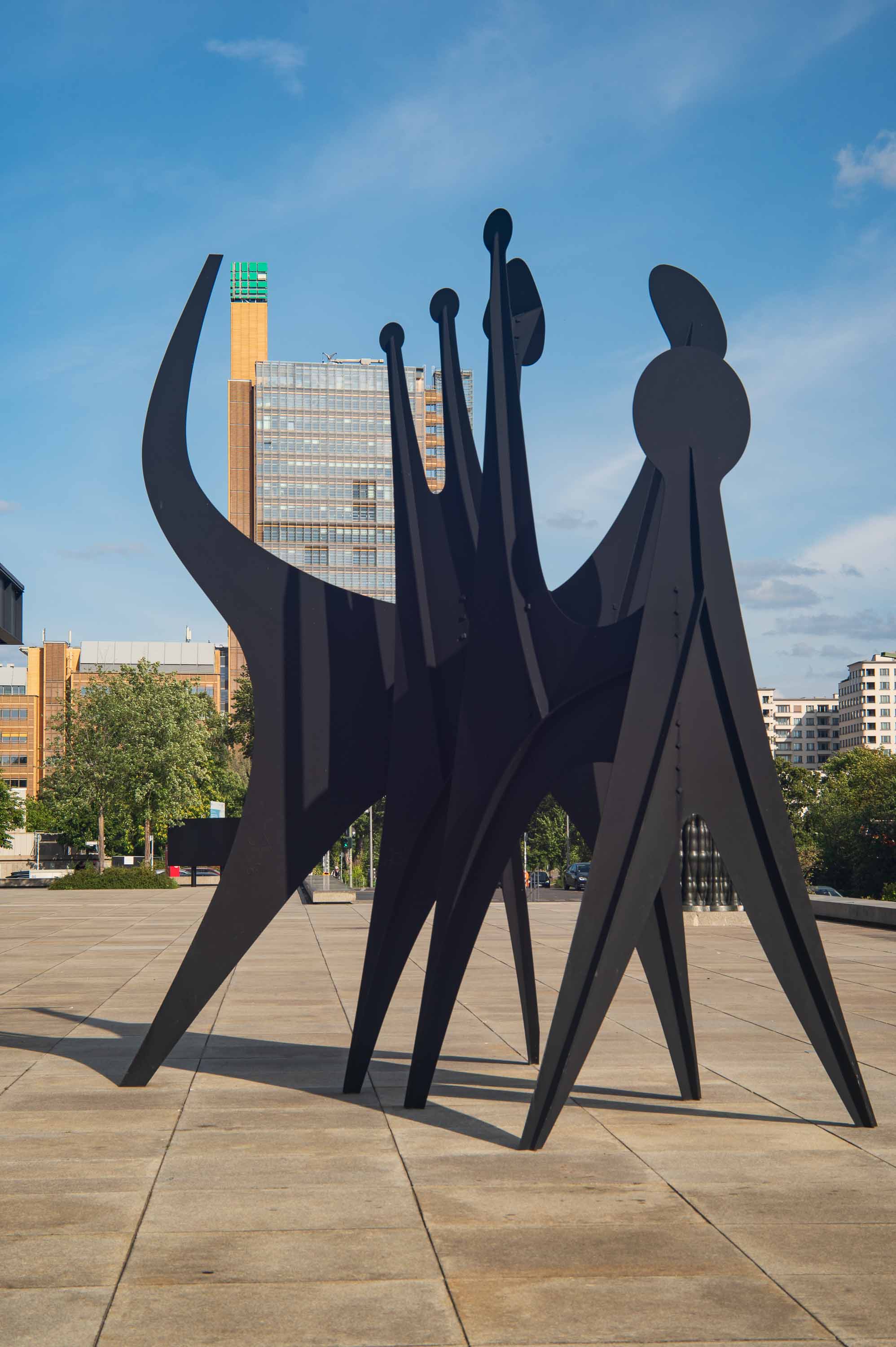 A sculpture of sharp, black angular forms cuts against the Berlin sky.