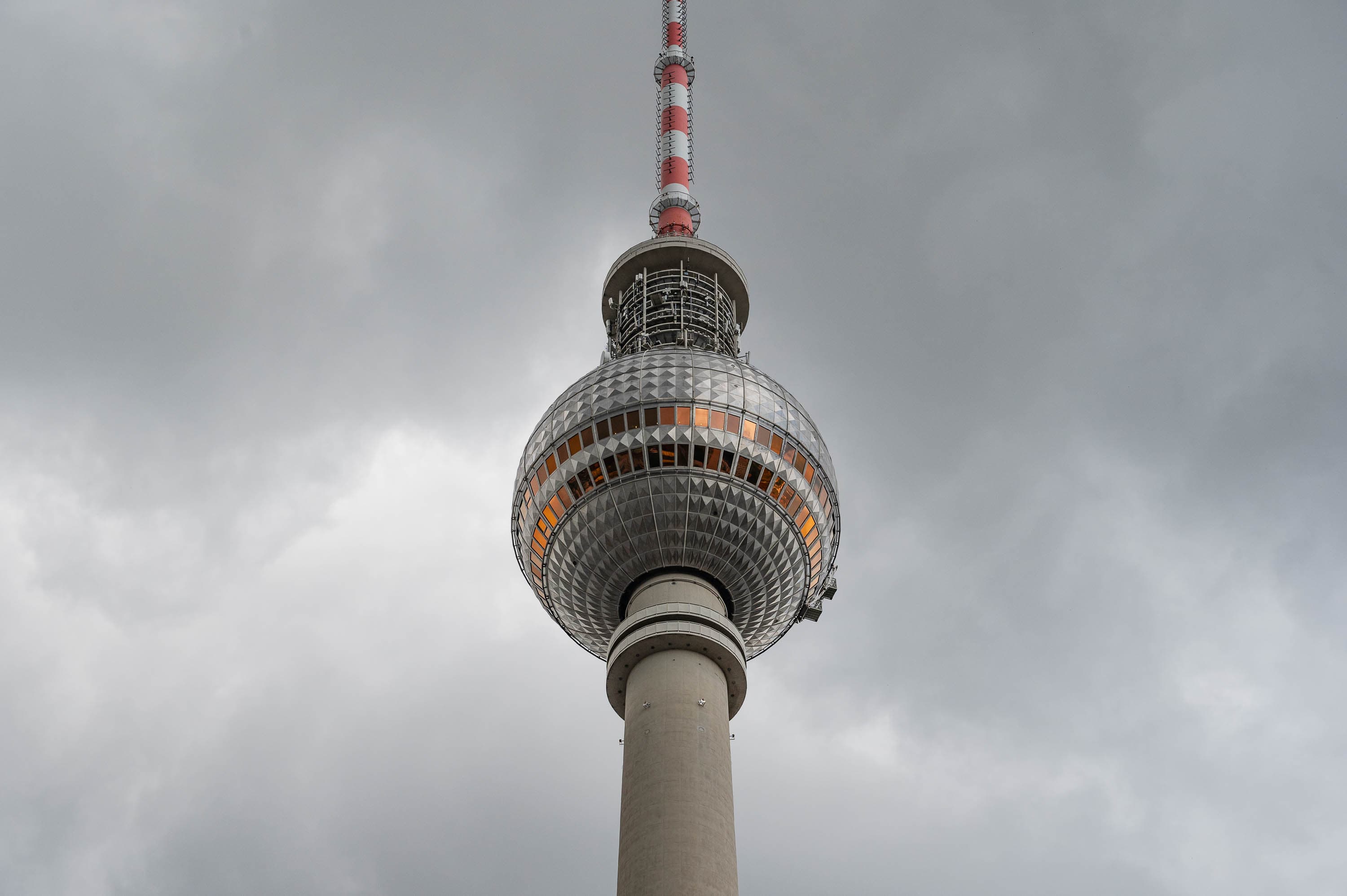 The Alexanderplatz Fernsehturm stands out against a sky of heavy clouds, a symbol of socialist Berlin that refuses to apologize for its origins.