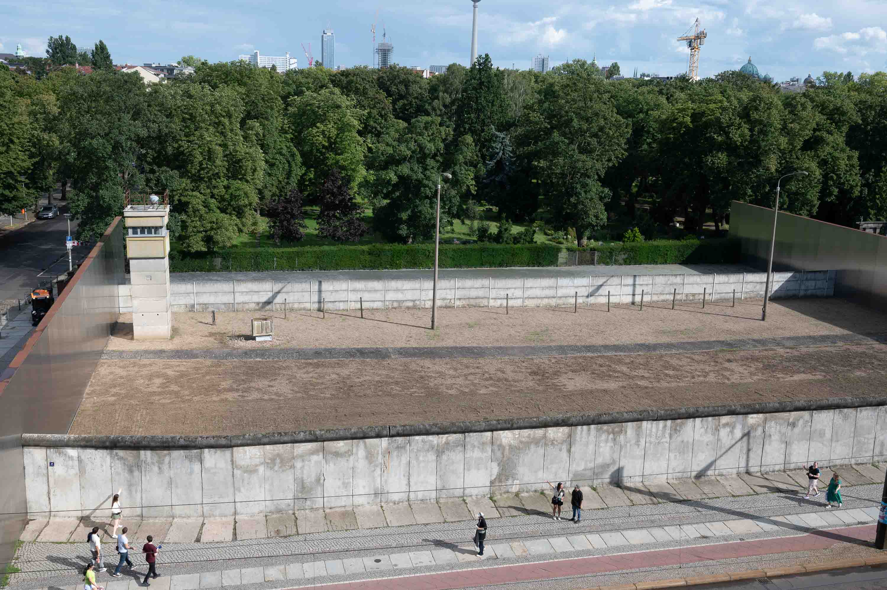 The Bernauer Strasse Memorial, seen from an elevated walkway: the death strip exactly as it was, with its two walls, no-man's-land, and a watchtower.