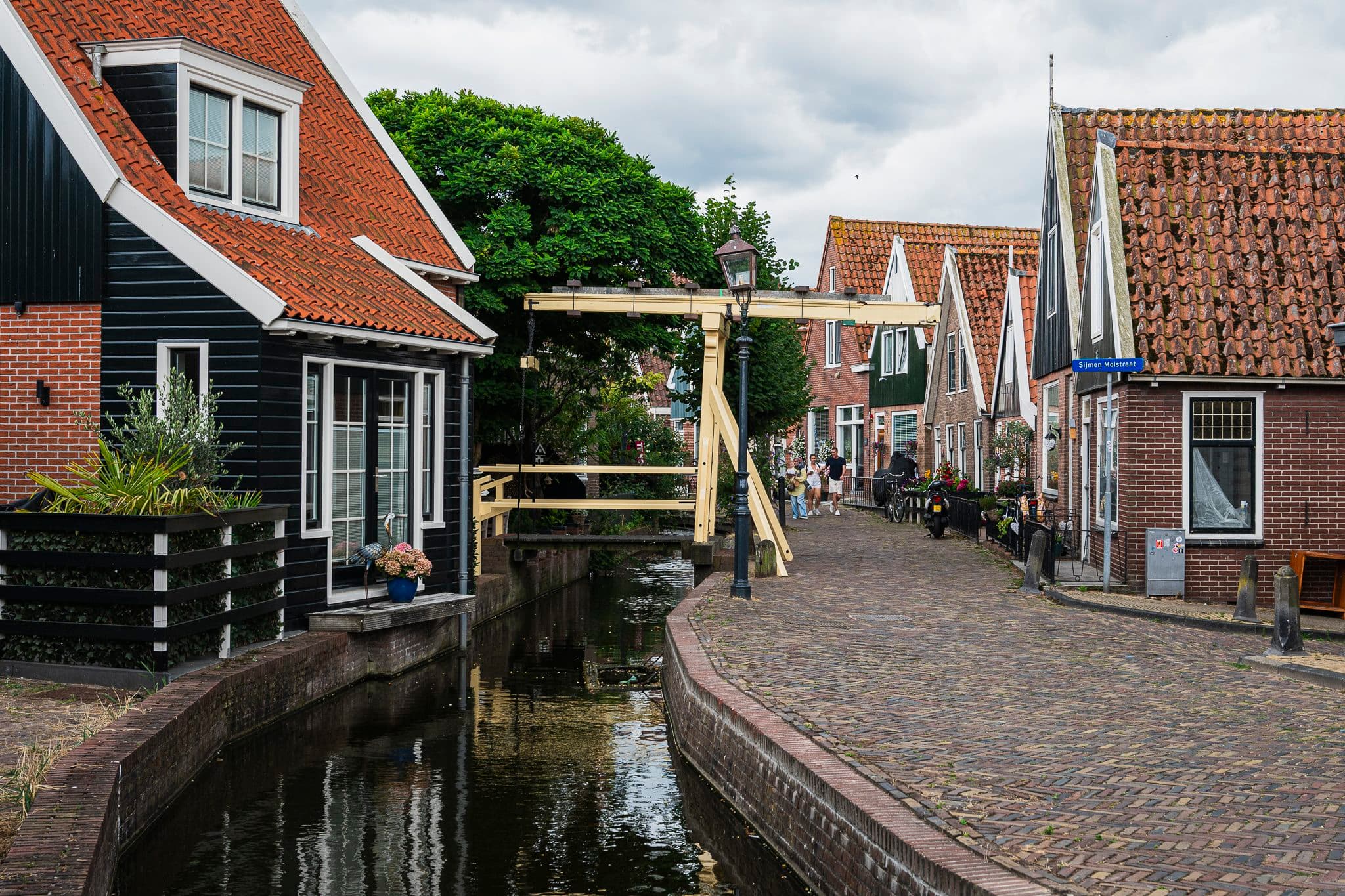 Volendam canal with a drawbridge and brick houses