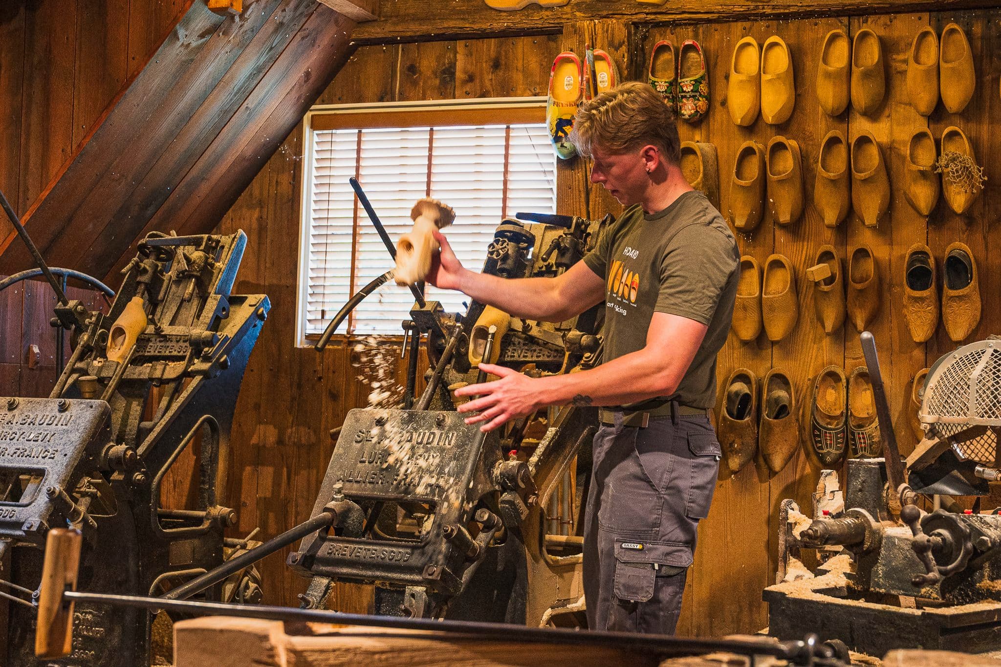 Craftsman carving a wooden clog in the Zaanse Schans workshop